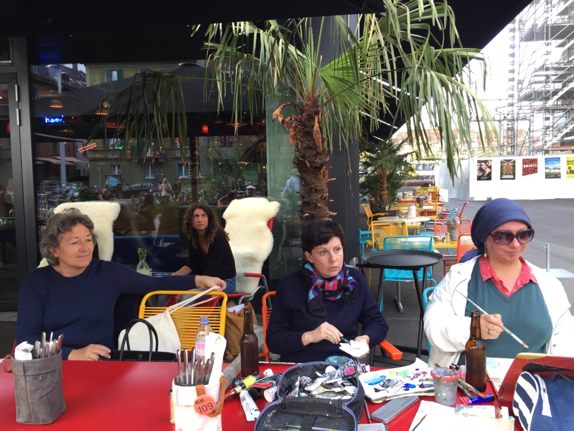 Anna Lukashevsky and Maria Pomiansky painting in front of the hotel
