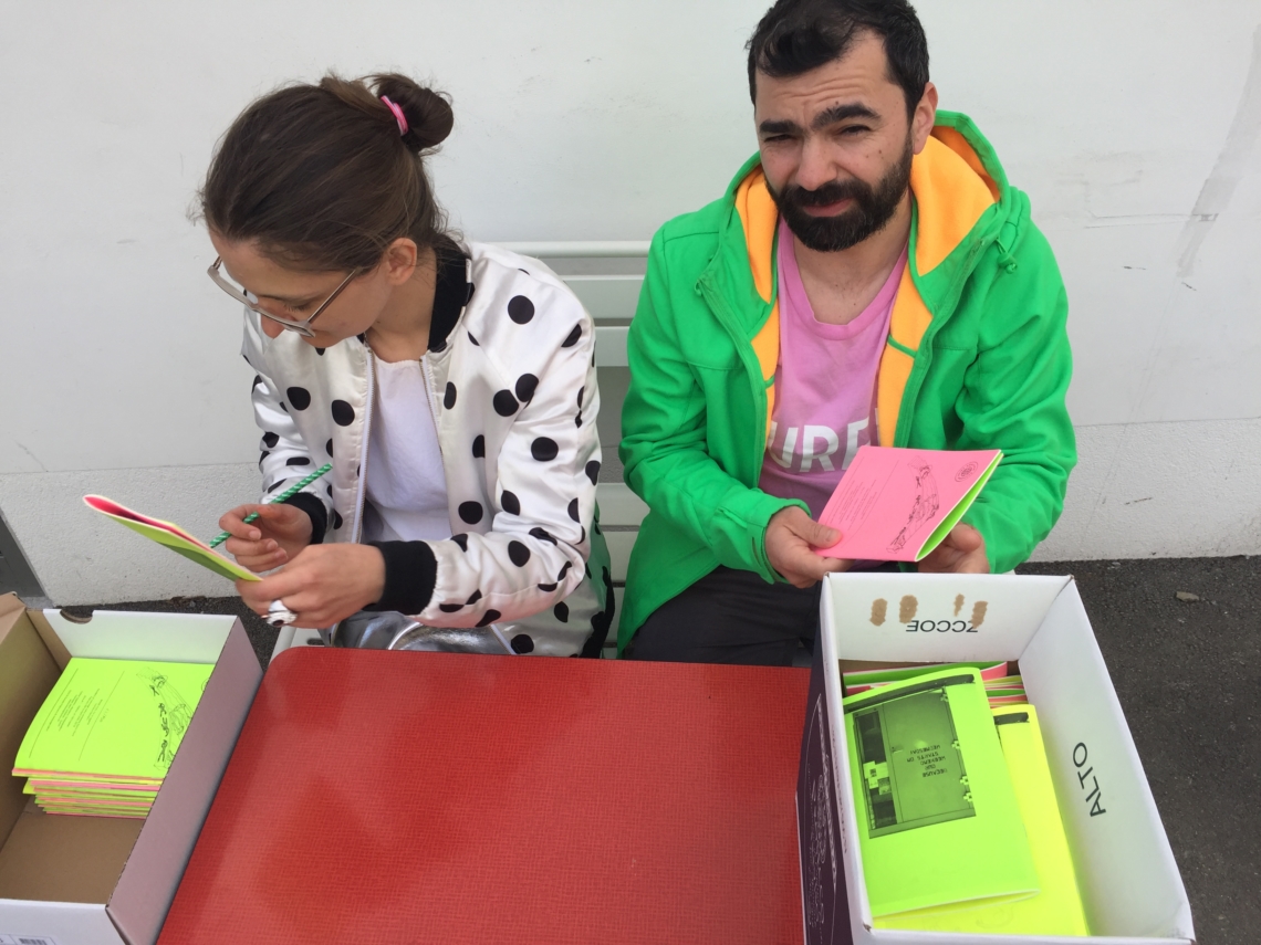 Daniela Palimariu signs the zines, with a little help from Alexandru Niculescu, co-founder of Sandwich Gallery Bucharest